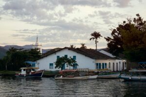 Colorful colonial buildings and cobblestone streets in Paraty with boats moored along the waterfront