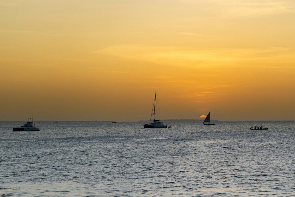 A group of boats floating on top of a large body of water