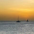 A group of boats floating on top of a large body of water