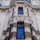 a tall building with many windows and a sky background