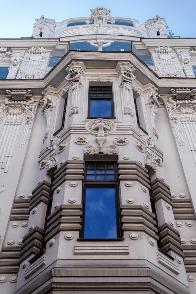 a tall building with many windows and a sky background