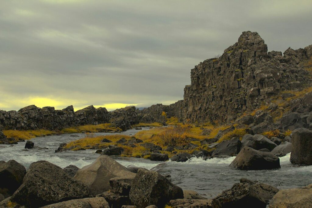 a rocky beach with a sunset