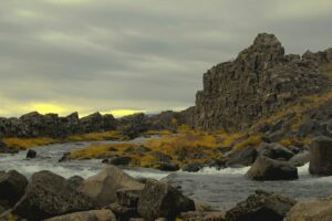 a rocky beach with a sunset