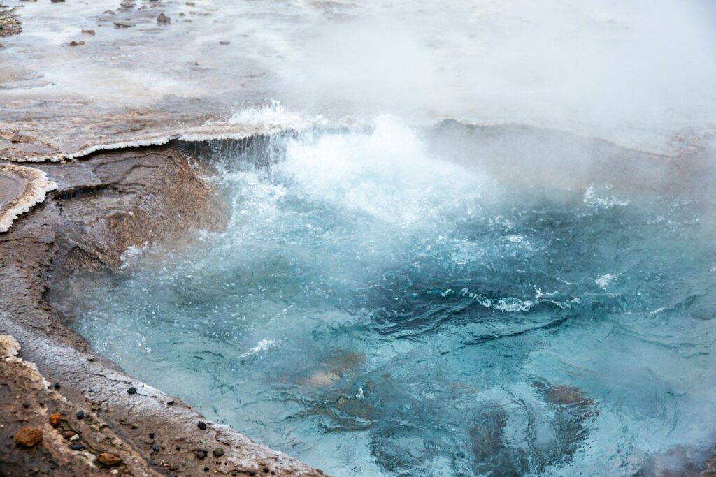 Bubbling hot spring with steam rising