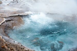 Bubbling hot spring with steam rising